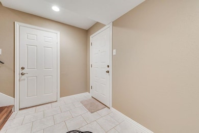 Foyer entrance featuring light tile patterned floo