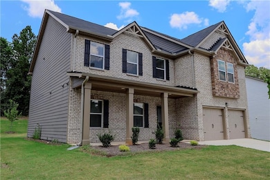 Craftsman-style house with a porch, a garage, brick siding, a front yard, and concrete driveway