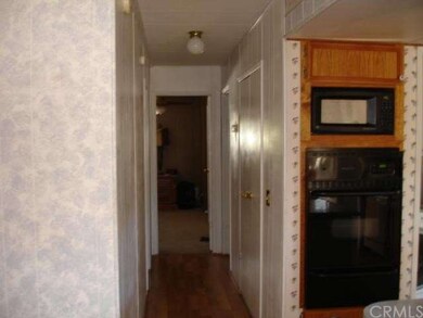 Hall way with the built in oven and microwave.