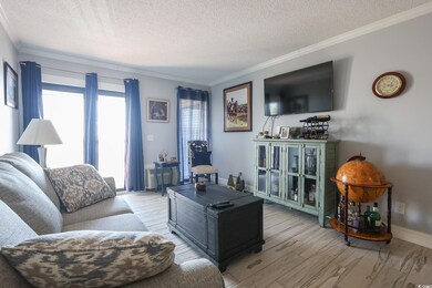 Living area with light wood finished floors, baseb