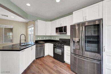Kitchen featuring a sink, dark countertops, a peni