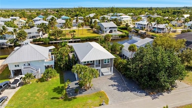 Aerial perspective of suburban area featuring a large body of water