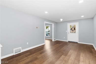 Entrance foyer with recessed lighting and wood finished floors