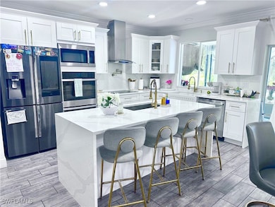 Kitchen with a kitchen bar, a center island with s