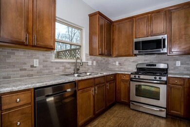 Kitchen with tasteful backsplash, appliances with 
