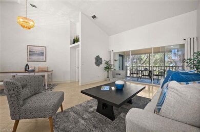 Living room featuring high vaulted ceiling, basebo