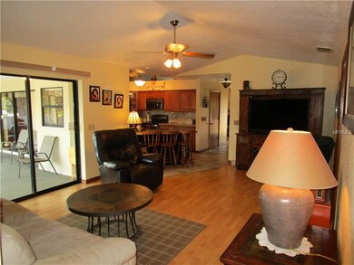 Family room overlooks kitchen, lanai, pool.