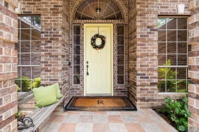 View of exterior entry featuring brick siding