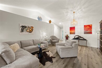 Living area with lofted ceiling, and chandelier