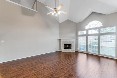 FAMILY ROOM - with beautiful wood laminate floors, cozy gas fireplace, high ceiling and big windows to allow for natural light.