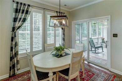 Wood floored dining room featuring ornamental mold
