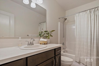 Full bath with vanity, shower / bath combination with curtain, and decorative backsplash