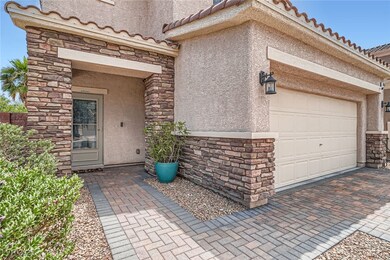 Property entrance featuring stucco siding, stone s