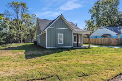 Back of property featuring board and batten siding, a fenced backyard, roof with shingles, and a porch