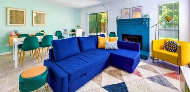 Living area with wood tiled floors, a brick firep