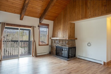 Living room featuring  wooden ceiling with exposed