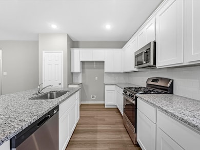 Granite countertops, a matching backsplash, and st
