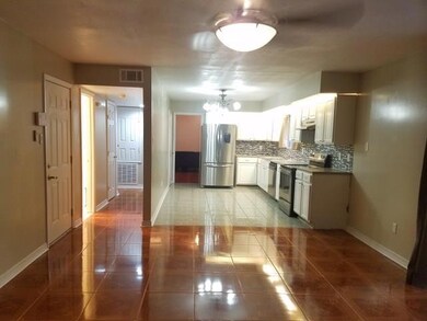 Kitchen into Hallway; half bath off hallway.
