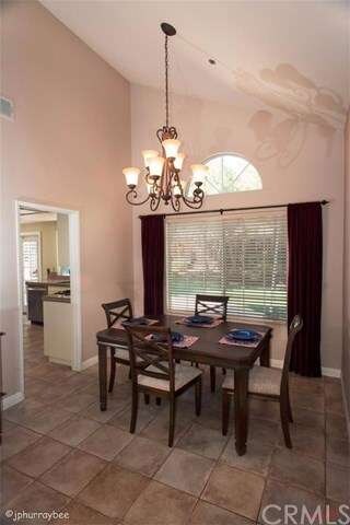 Dining room with beautiful chandelier. Tiled floor