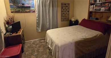 Bedroom with dark colored carpet