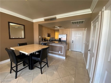 Dining area with crown molding and baseboards