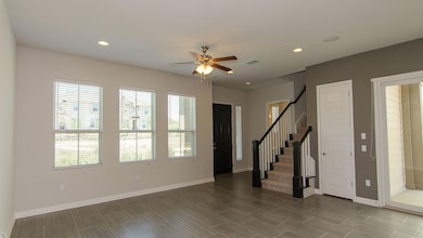Foyer with plenty of natural light, a ceiling fan