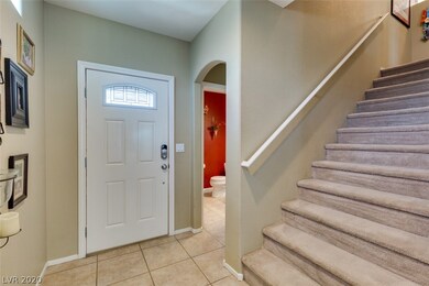 Front entry, guest bathroom, and stairway