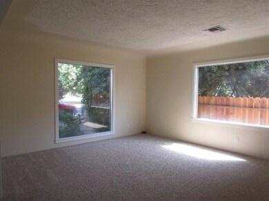 Living room with beautiful picture windows and custom ceiling treatment.  They don't build them like this anymore!