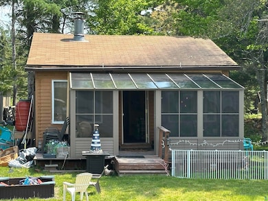 Back of property with a sunroom