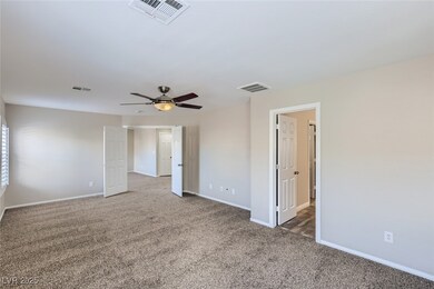 Spare room featuring visible vents, carpet, and ba