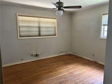 Unfurnished room featuring ornamental molding, wood finished floors, and a ceiling fan