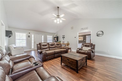 Living area with baseboards, high vaulted ceiling, a ceiling fan, and wood finished floors