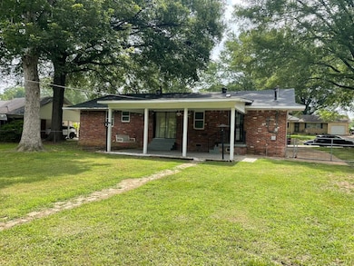 Rear view of house with brick siding