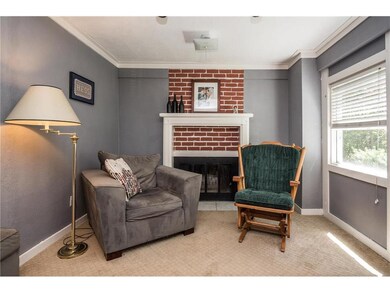 A cozy carpeted hearth sitting area with wood burn