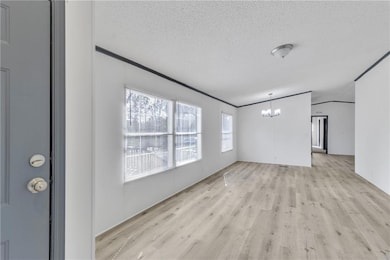 Unfurnished living room featuring vaulted ceiling,