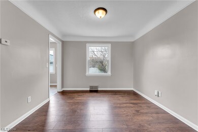 Unfurnished room with dark hardwood / wood-style floors