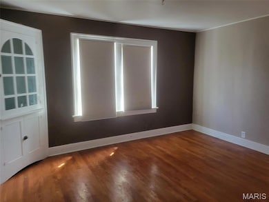 Empty room featuring wood finished floors and baseboards