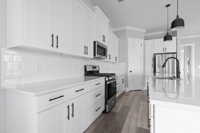 Kitchen featuring decorative backsplash, appliance