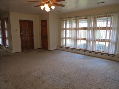 The living room is spacious, bathed in natural lig