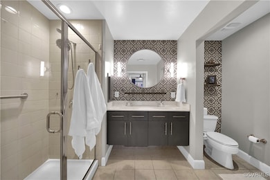Primary ensuite with dual floating vanity, step-in