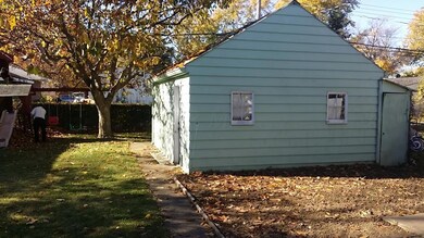 View of back yard and back of detached g