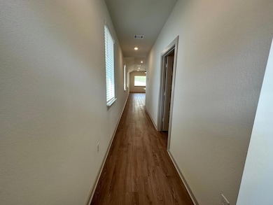 Corridor featuring dark wood-type flooring and re