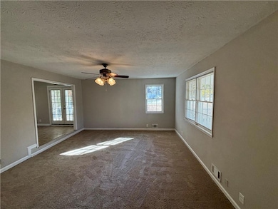 Spare room featuring french doors, carpet floors, 