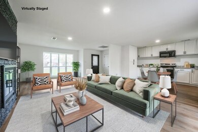 Living area with a stone fireplace, visible vents,