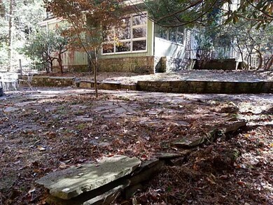 Patio/Deck. Stone patio at the back of the home wi