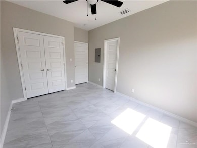 Unfurnished bedroom featuring a closet, baseboards, visible vents, and electric panel