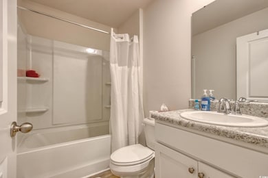Full bath featuring shower / tub combo with curtai