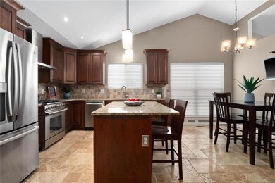Kitchen has vaulted ceiling, ceramic tile flooring