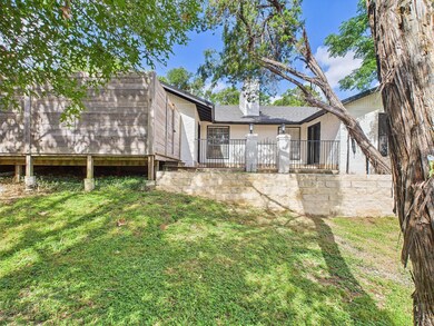 Rear view of property with a chimney and a lawn