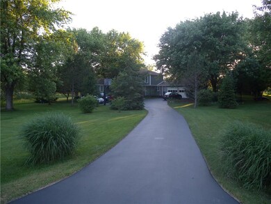 The freshly sealed driveway brings you into this w